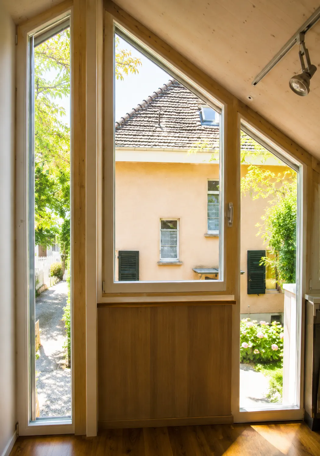 Geöffnete Tür, Blick in ein lichtdurchflutetes Architekturbüro mit Zeichentisch und Regalen